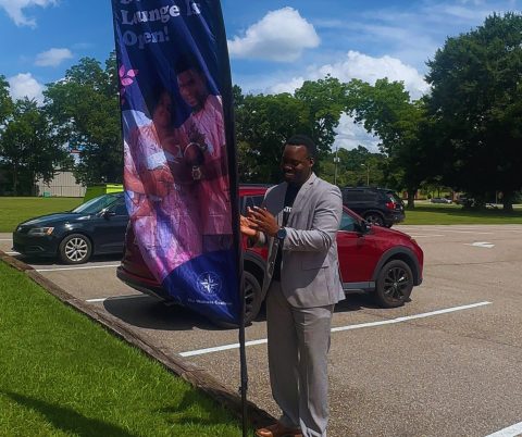 Pastor Dwayne Campbell set the Breastfeeding Lounge flag, signifying that it is open for service.